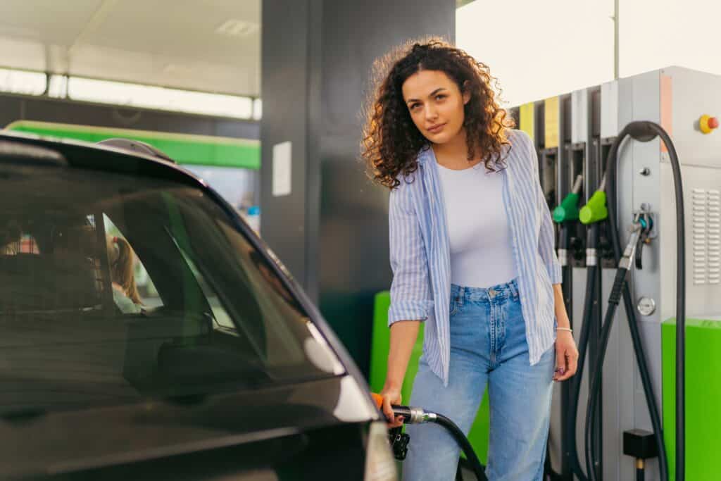Woman charging EV at a public charging station